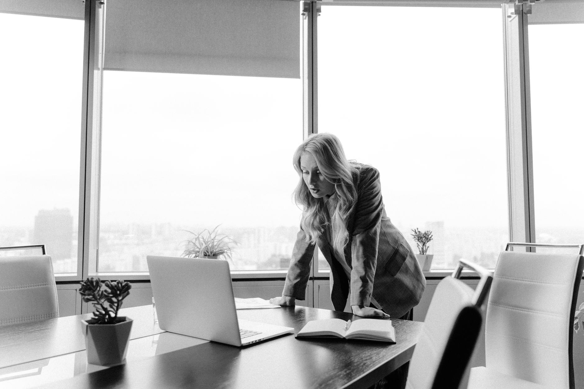 woman in a blazer inside a conference room